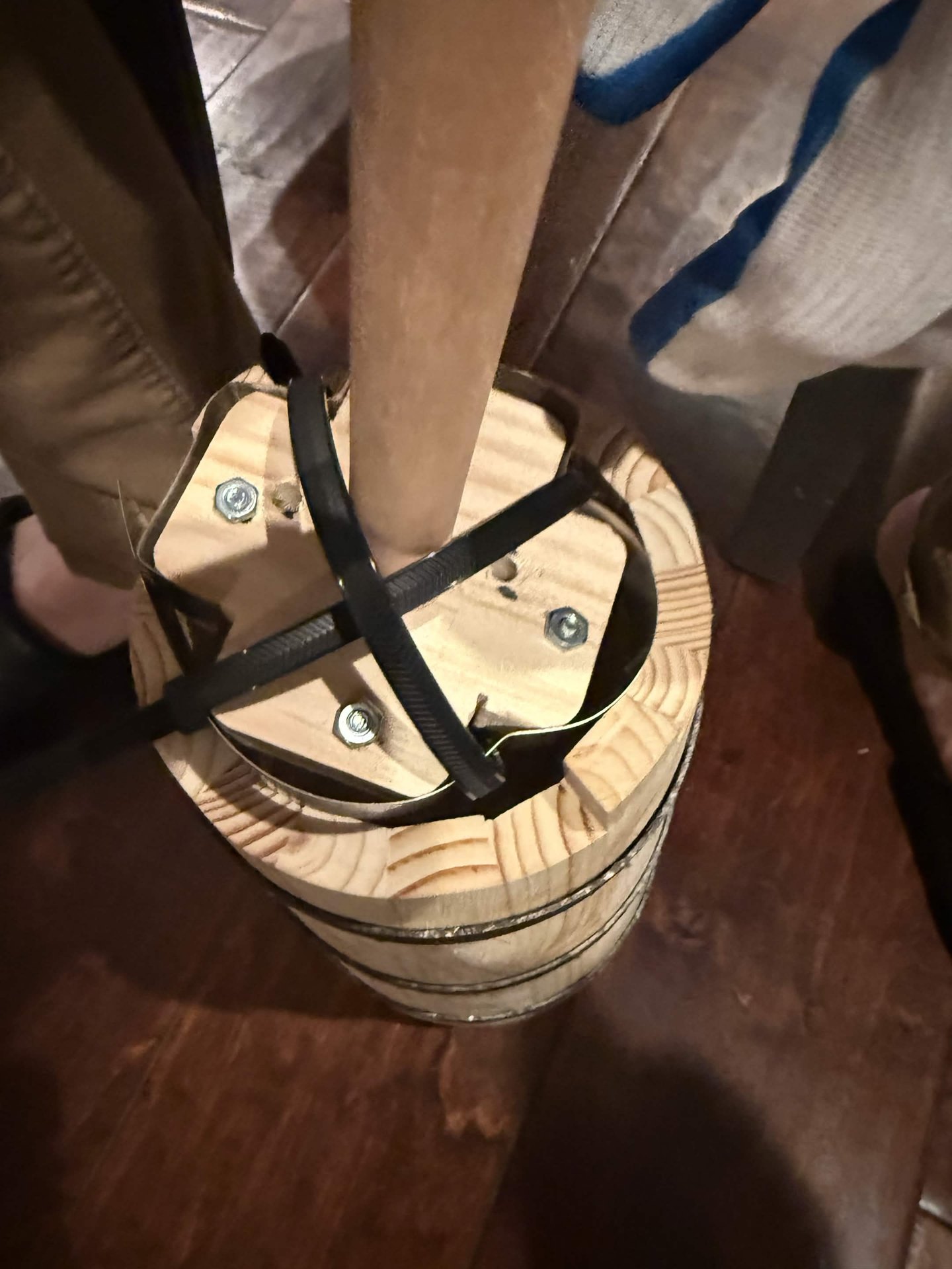 Plunger assembly fitted into the wooden churn with screws and cable ties